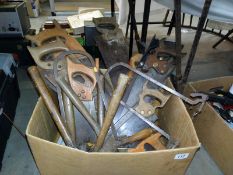 A large box of various saws and hammers