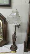 A figural table lamp with glass shade (needs re-wiring).