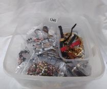 A large box of costume jewellery including wristwatches