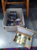 A tin of lighters, other tins, a camera and a box collection of lava samples