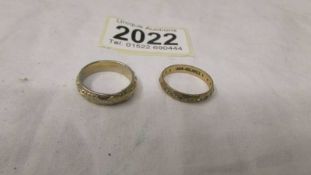 A 9ct gold eternity ring and a yellow metal ring.