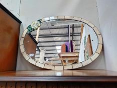 A large oval glass wall mirror drilled for fixing to wall (84cm x 59cm) COLLECT ONLY