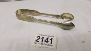 A pair of silver sugar tongs.