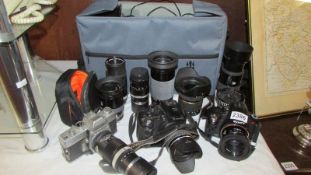 Three camera's - Sony, Fujifilm and Minolta together with 7 lenses, cables etc., in bag.
