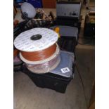 A heavy duty tool box and 2 rolls of 0.75 brown insulated wire.