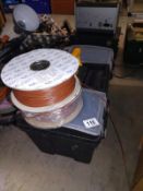 A heavy duty tool box and 2 rolls of 0.75 brown insulated wire.