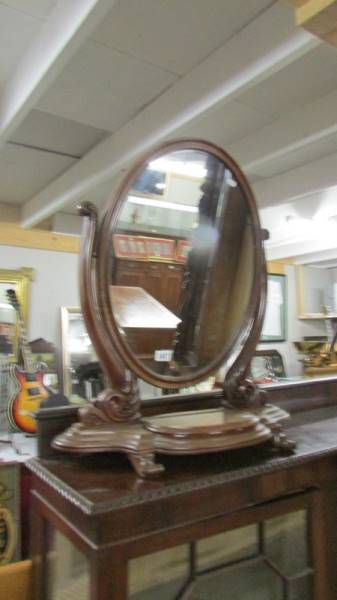 An oval Victorian mahogany toilet mirror. COLLECT ONLY.