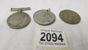 A WW2 medal, a 1935 jubilee medal and a 1953 Coronation medal.