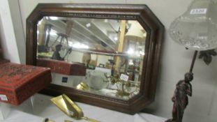 An oak framed bevel edged mirror.