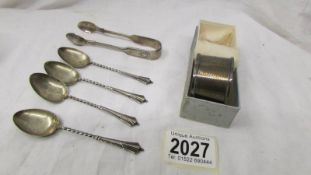 Four silver spoons, a silver napkin ring and silver sugar tongs, 49 grams.