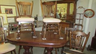 An oval mahogany dining table and a set of six oak chairs, COLLECT ONLY.