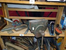 A shelf of tools including a quick release vice.