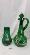 A Mary Gregory style green glass vase and a green glass a/f claret jug.