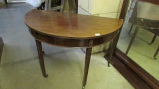 A mahogany D shaped table on tapered legs. COLLECT ONLY.
