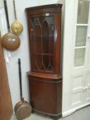 A dark wood stained and glazed corner cabinet