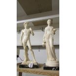 Two classical style figures on marble bases.