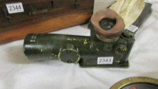 An old gun scope, magnification B00-oo, E 01 00.H.