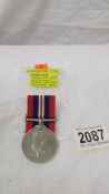 A 1939-45 Service medal with ribbon, D Beresford Esq., in original box, in very good condition.