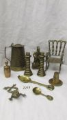 A pair of heavy brass candlesticks, a brass Dicken's figure, a Brass lidded jug and other brassware.