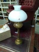 A brass column oil lamp with white mushroom shade