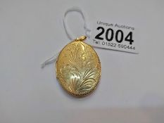 A 9ct gold floral engraved locket, 11 grams.