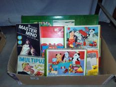 A quantity of vintage board games and jigsaws including Sooty, Disneyland and Master mind etc