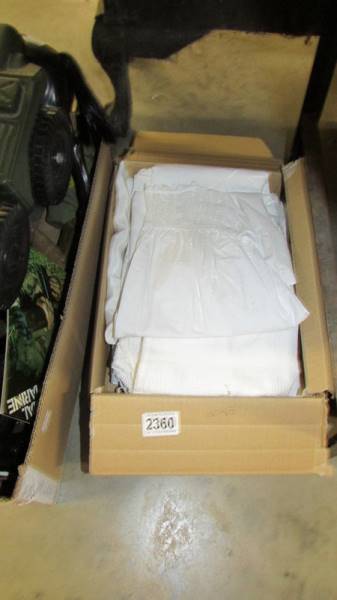 A box of vintage baby gowns.