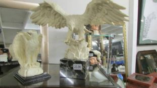 Two eagle figures.