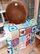 A hand crocheted blanket and a small pouffe