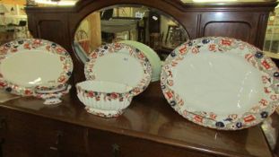 Three graduated meat platters, a sauce tureen and another tureen (missing lid) COLLECT ONLY.