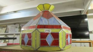 A large stained and leaded glass lampshade.