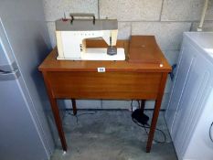 A Singer sewing machine, model 377, with table, pedal, etc