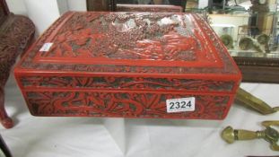 An oriental cinabar lacquered box, 28.5 c 24 x 9 cm.