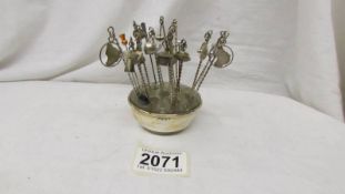 Approximately 20 vintage hat/stick pins in stand.