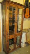 A modern oak display cabinet, (missing one lower door panel) 73 x 34 x 179 cm high, COLLECT ONLY.