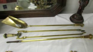 A set of three brass fire irons.