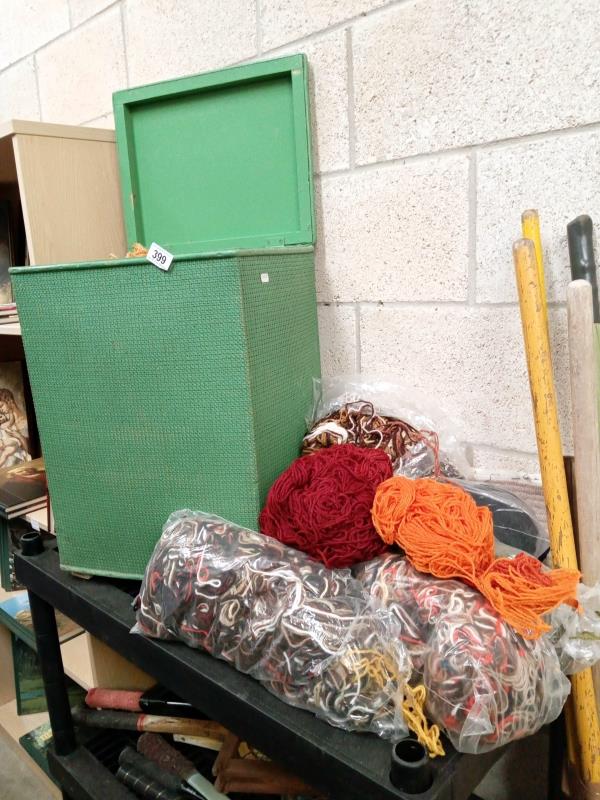 A Lloyd loom style laundry basket with a large lot of wool/embroidery