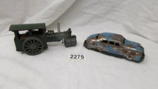 A Triang Minic tinplate clockwork steam roller and a tinplate American car.