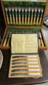 A cased set of 12 fish knives and forks together with a cased set of six butter knives.