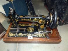 A decorative cased Singer sewing machine