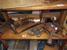 A shelf of wood planes etc