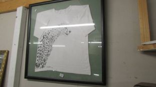 A framed and glazed hand painted Tee shirt, signed by artist. COLLECT ONLY.