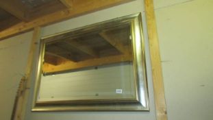 A bevel edged mirror in silver coloured frame, COLLECT ONLY.