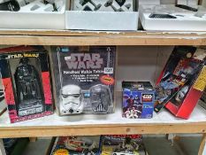 A quantity of vintage STar Wars items all in packaging including walkie talkies and alarm clock.