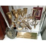 A shelf of brassware