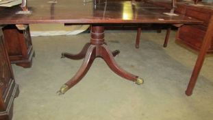 A mahogany dining table with central pedestal. COLLECT ONLY.