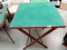 A green felted foldable card table