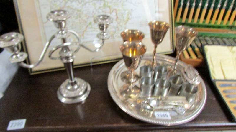 A silver plate tray, candelabra, goblets, napkin rings etc.,