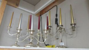Four silver plate candelabra.