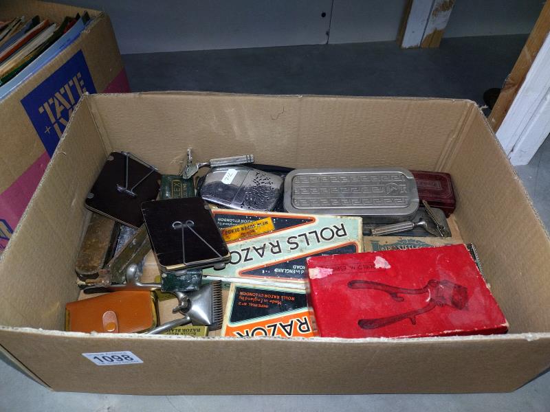 A box of mixed items including Rolls razors